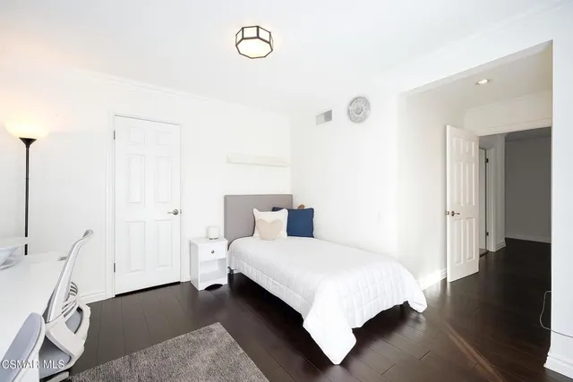 a bathroom with a granite countertop sink a toilet a mirror and shower