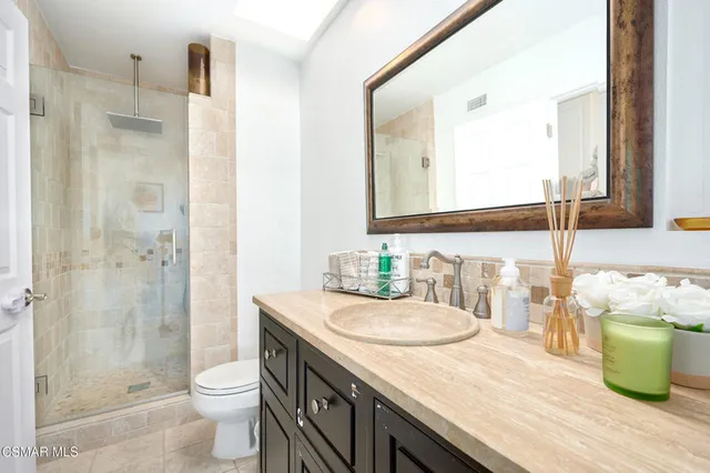 a backyard of a house with fire pit and outdoor seating