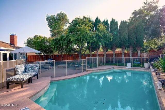 an aerial view of a house with garden space and outdoor seating