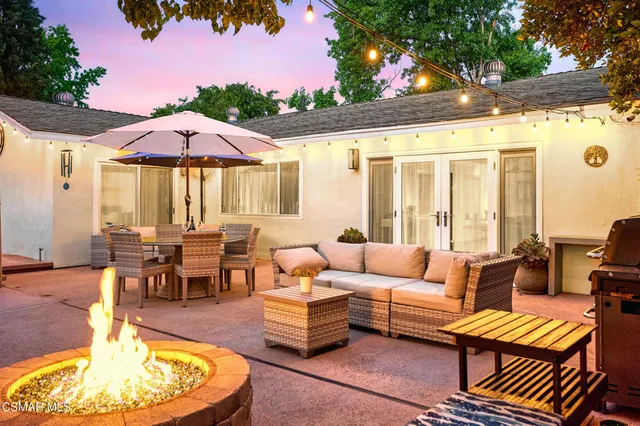 an outdoor space with seating area and trees