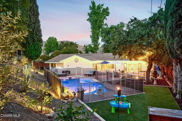 a view of a swimming pool with an outdoor seating