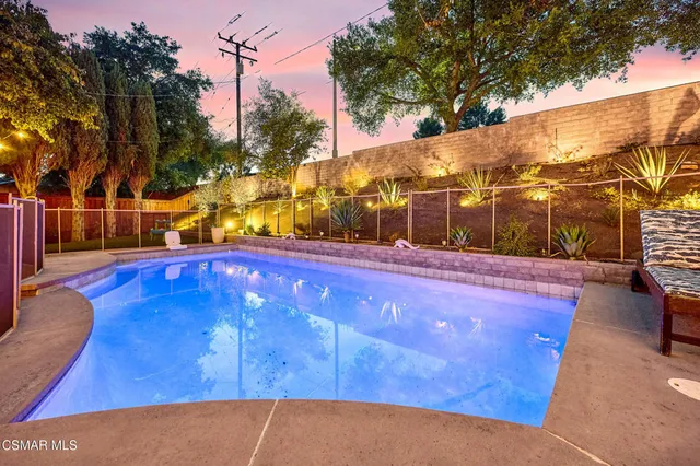 a view of swimming pool with outdoor seating