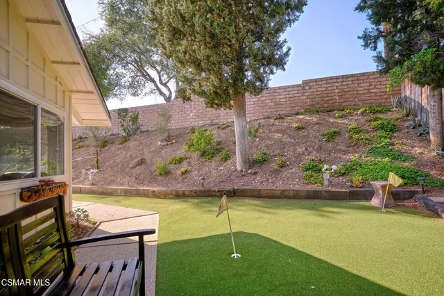 an aerial view of a house with a yard and a fountain