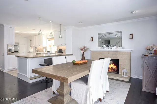 a kitchen with a table chairs and a fireplace