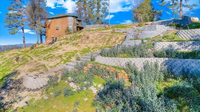 a view of swimming pool with a yard and trees