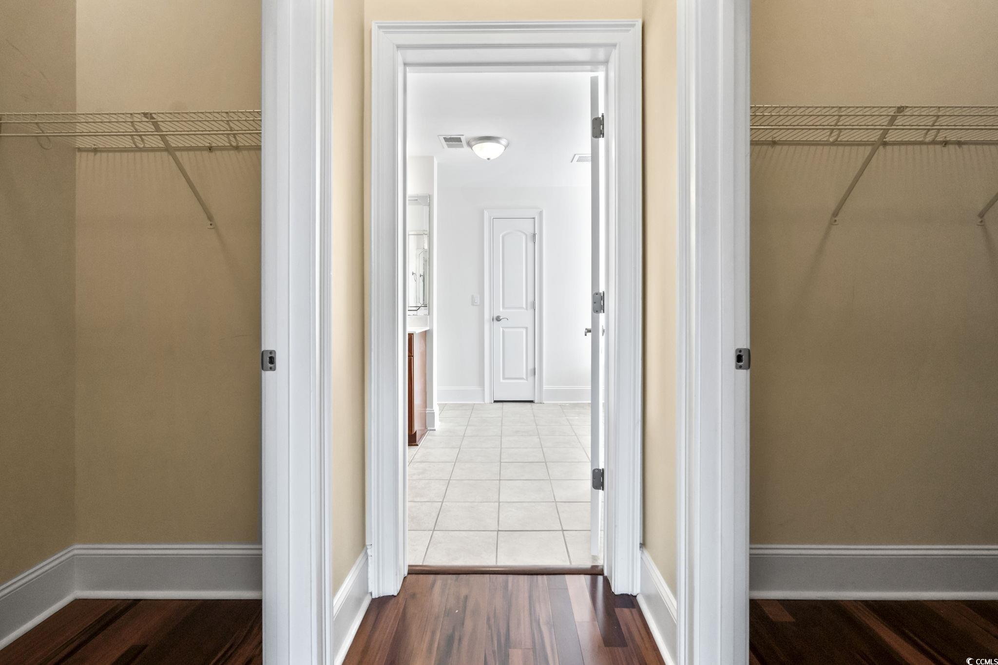 249 Venice Way, Unit 3301 Myrtle Beach, SC 29577 - Photo 21 of 40 Walk in closet with dark wood finished floors