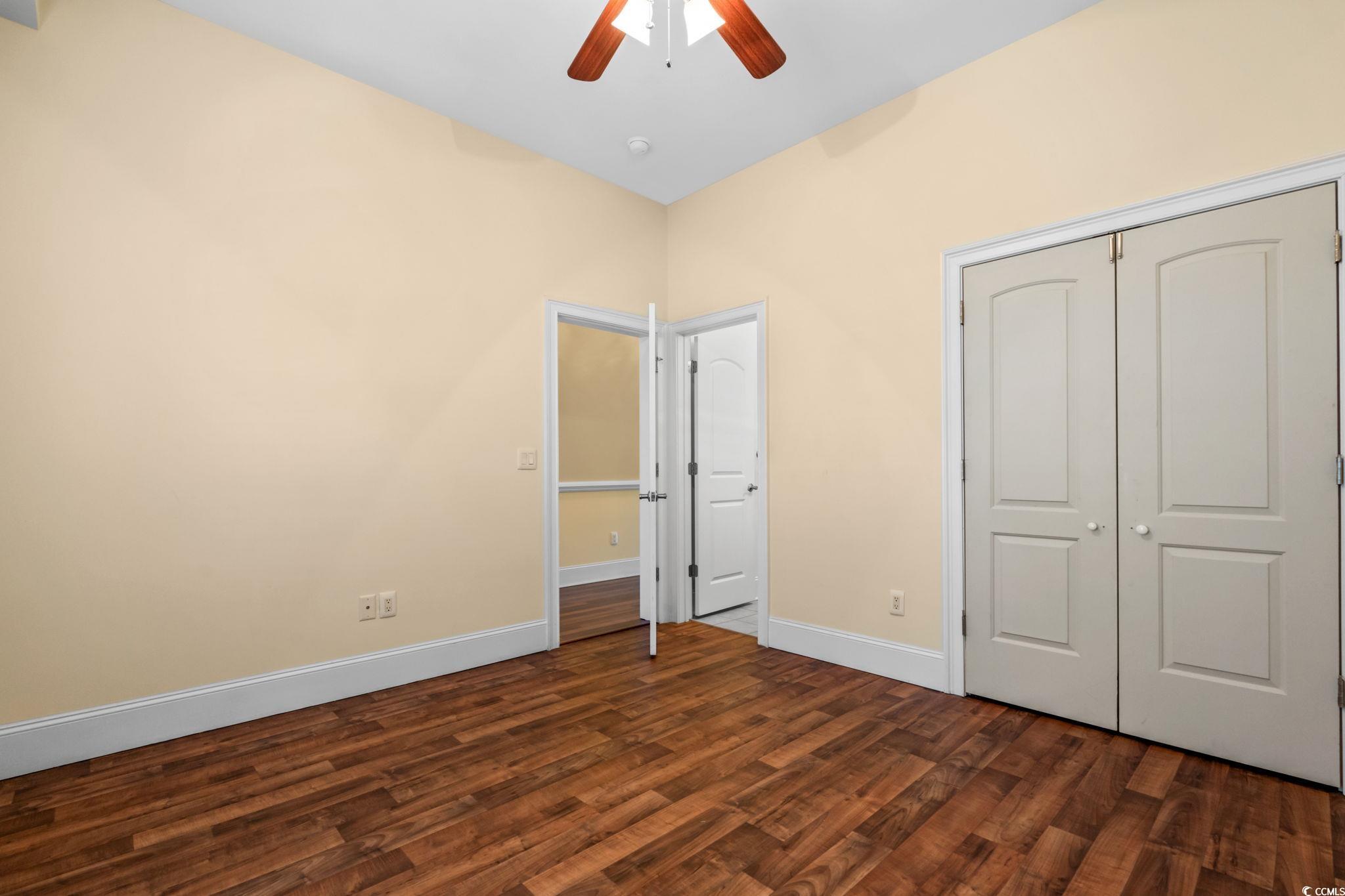249 Venice Way, Unit 3301 Myrtle Beach, SC 29577 - Photo 27 of 40 Unfurnished bedroom featuring dark wood-style floors, a closet, and a ceiling fan