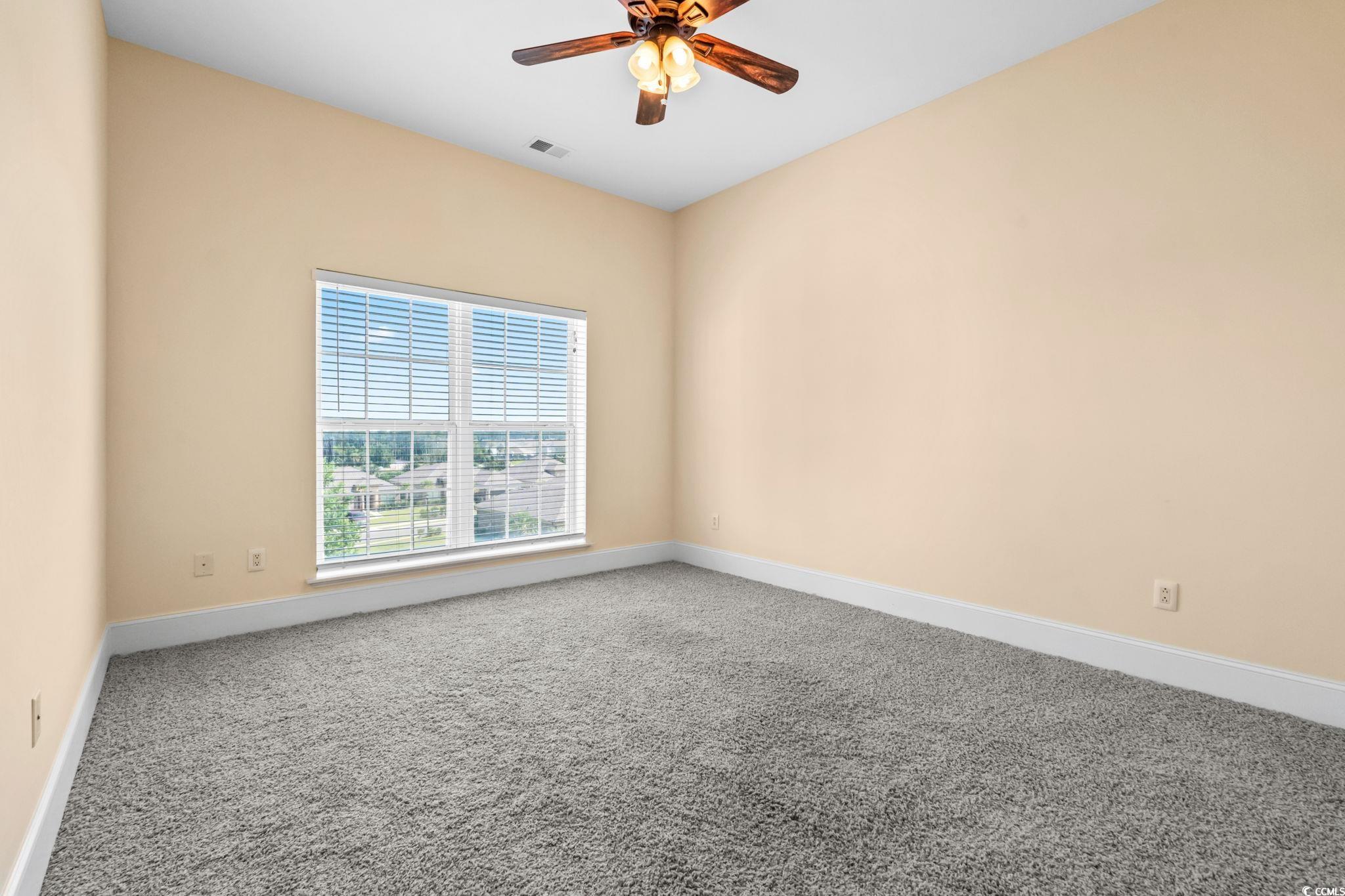 249 Venice Way, Unit 3301 Myrtle Beach, SC 29577 - Photo 30 of 40 Carpeted empty room featuring a ceiling fan and baseboards