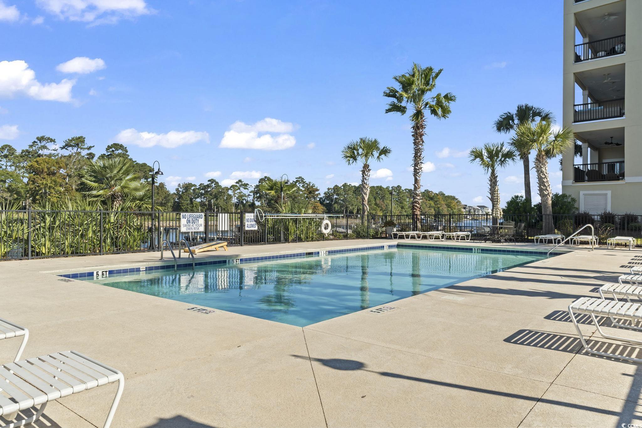 249 Venice Way, Unit 3301 Myrtle Beach, SC 29577 - Photo 35 of 40 Community pool with a patio