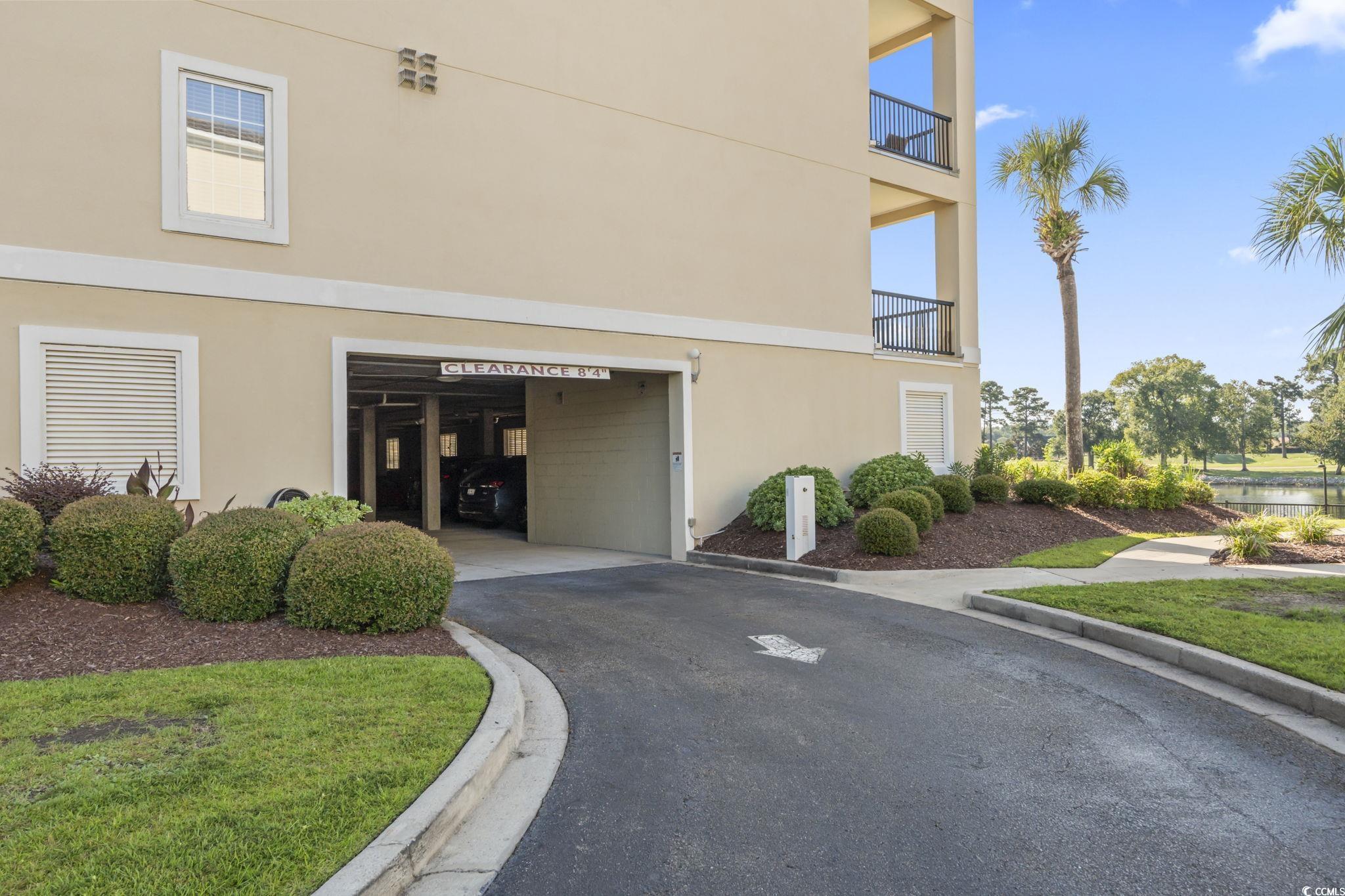 249 Venice Way, Unit 3301 Myrtle Beach, SC 29577 - Photo 37 of 40 View of home's exterior with stucco siding, driveway, and an attached garage