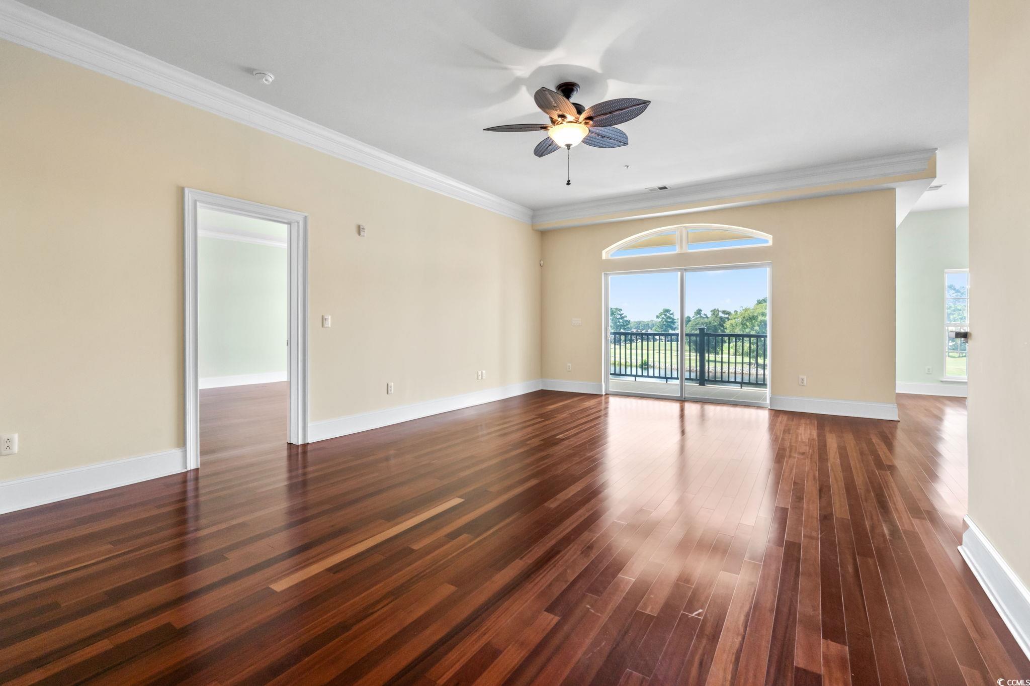 249 Venice Way, Unit 3301 Myrtle Beach, SC 29577 - Photo 4 of 40 Unfurnished room with dark wood-style floors, a ceiling fan, and crown molding