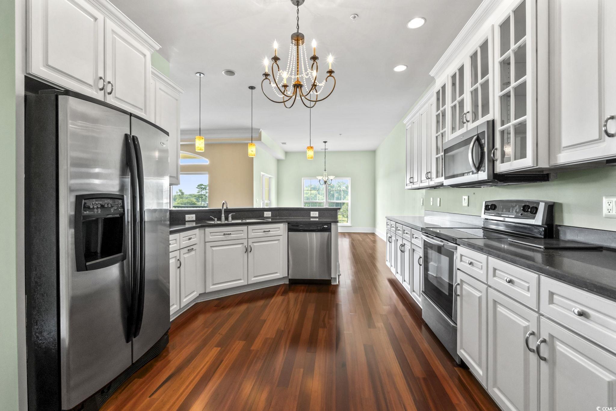 249 Venice Way, Unit 3301 Myrtle Beach, SC 29577 - Photo 9 of 40 Kitchen with a chandelier, appliances with stainless steel finishes, white cabinets, dark wood-type flooring, and recessed lighting
