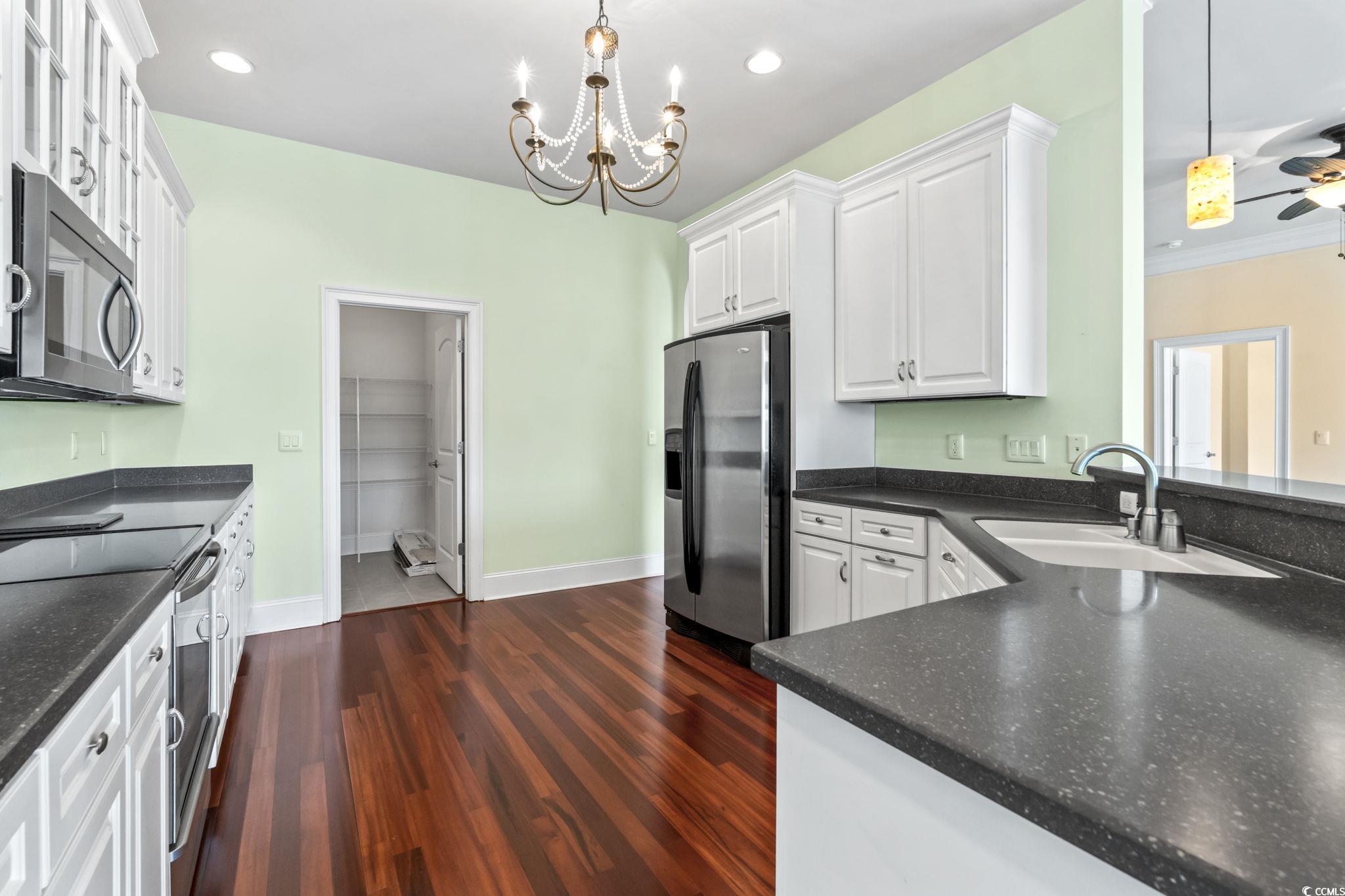249 Venice Way, Unit 3301 Myrtle Beach, SC 29577 - Photo 10 of 40 Kitchen with appliances with stainless steel finishes, white cabinetry, dark wood finished floors, pendant lighting, and recessed lighting