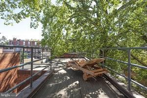 1312 R Street Northwest, Unit B Washington, DC 20009 - Photo 13 of 17 a view of a balcony with wooden floor and outdoor seating