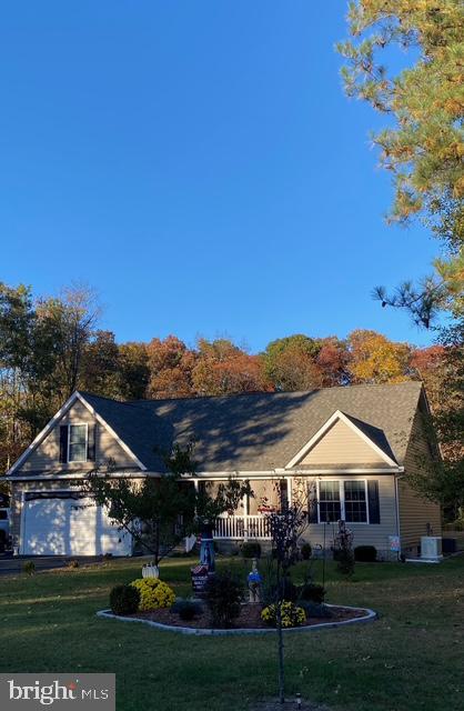 6503 Pleasant Drive Laurel, DE 19956 - Photo 2 of 3 a front view of a house with a garden