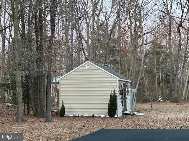 6503 Pleasant Drive Laurel, DE 19956 - Photo 3 of 3 a view of a white house with large trees and wooden fence