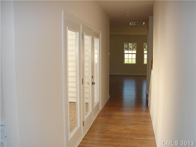 4009 Perth Road, Unit 402 Indian Land, SC 29707 - Photo 3 of 8 a view of a hallway with wooden floor and staircase
