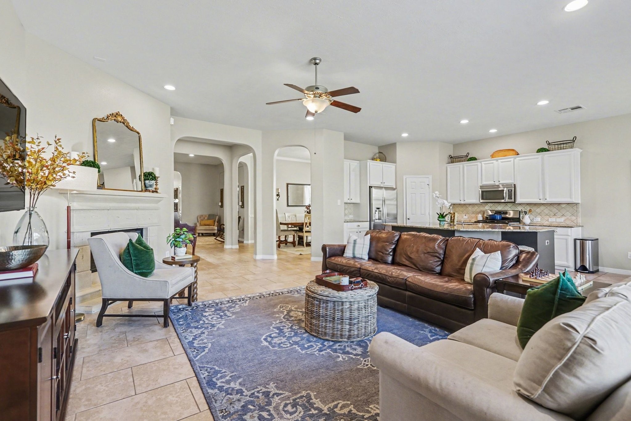27006 Cliff Pointe Lane Katy, TX 77494 - Photo 8 of 34 Comfort meets functionality in this expansive living space, offering flexibility for furniture placement and effortless connection to the kitchen and dining areas.