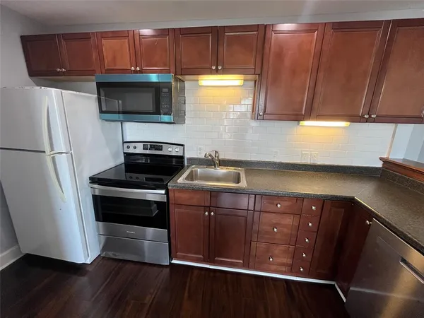a kitchen with a sink and a microwave
