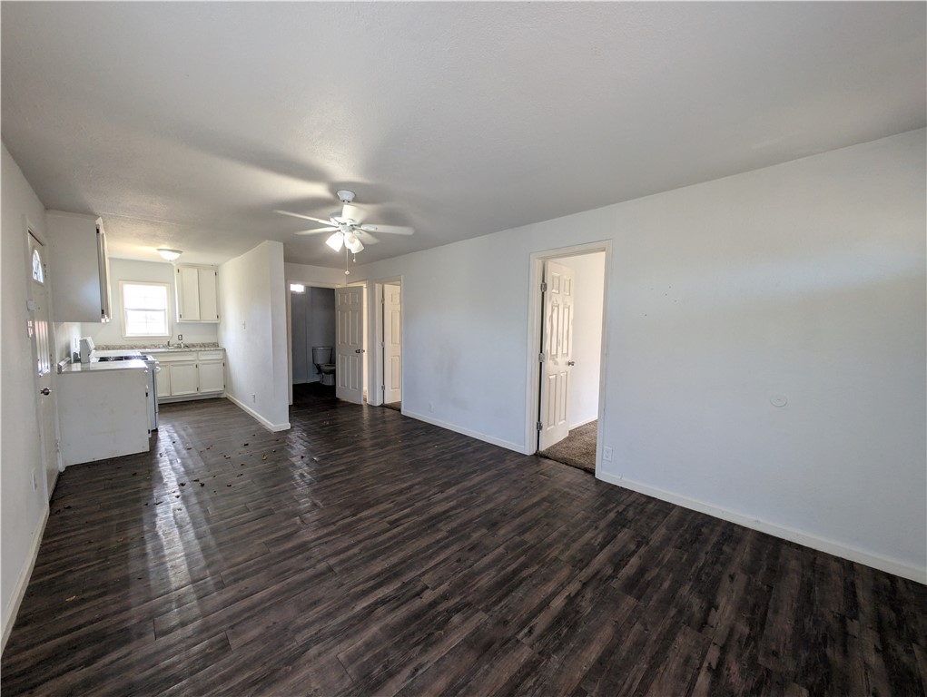 610 25th Street Corpus Christi, TX 78405 - Photo 2 of 11 a view of an empty room with wooden floor and a kitchen
