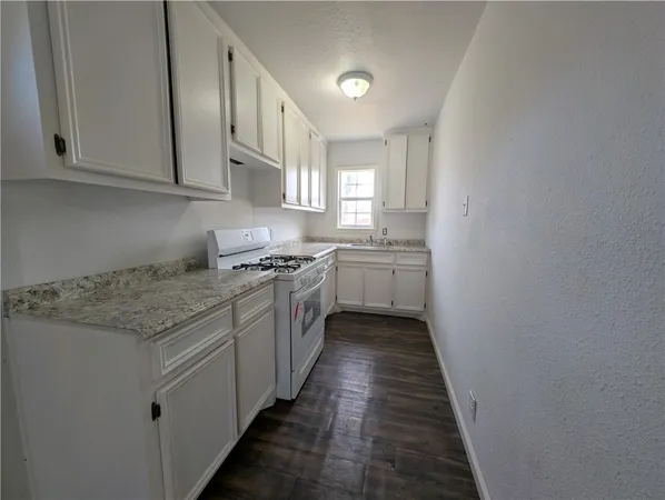 a kitchen with stainless steel appliances granite countertop a stove and a sink