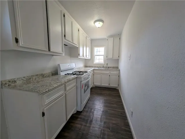 a kitchen with stainless steel appliances granite countertop a stove and a sink