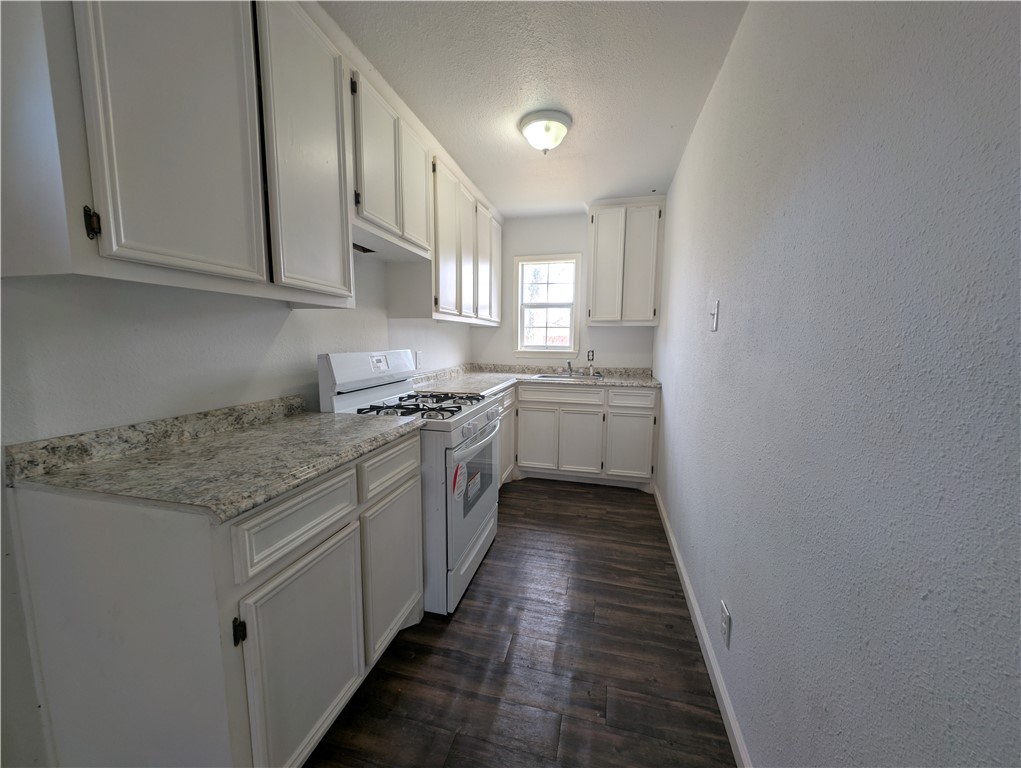 610 25th Street Corpus Christi, TX 78405 - Photo 3 of 11 a kitchen with stainless steel appliances granite countertop a stove and a sink