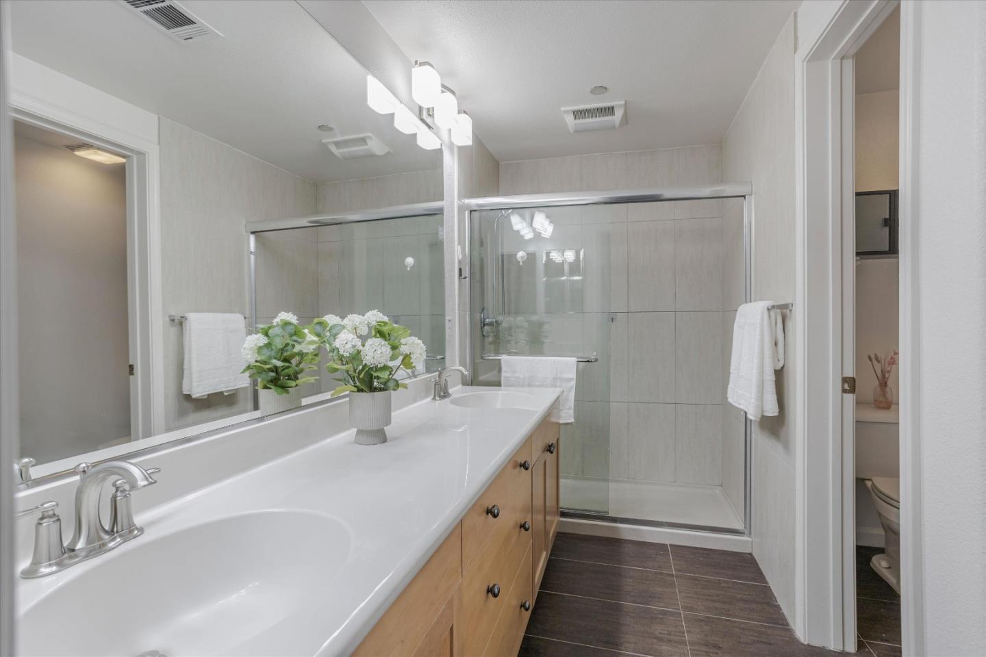 105 Serenity Place Milpitas, CA 95035 - Photo 27 of 36 a bathroom with a granite countertop sink a mirror and a shower