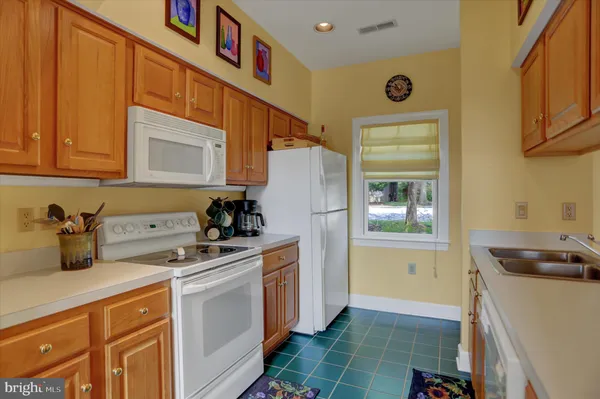 a utility room with cabinets washer and dryer