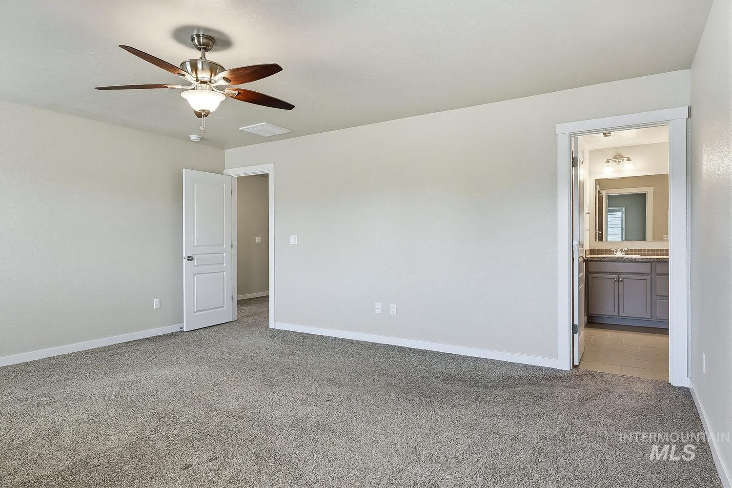 846 North Hidden View Way Star, ID 83669 - Photo 33 of 49 Spacious carpeted room featuring light gray walls and a ceiling fan with wood-finish blades