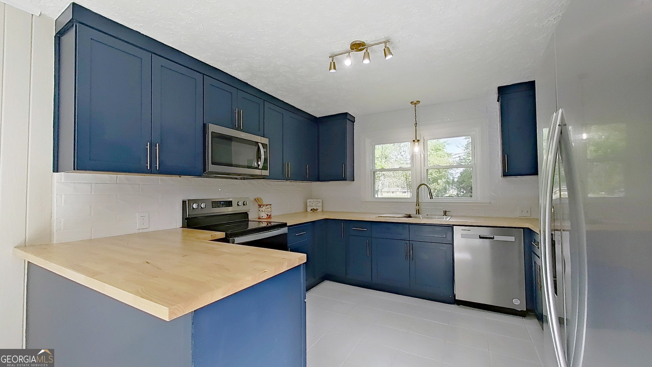 481 4th Street Southeast Cairo, GA 39828 - Photo 11 of 55 a kitchen that has a sink and a stove in it