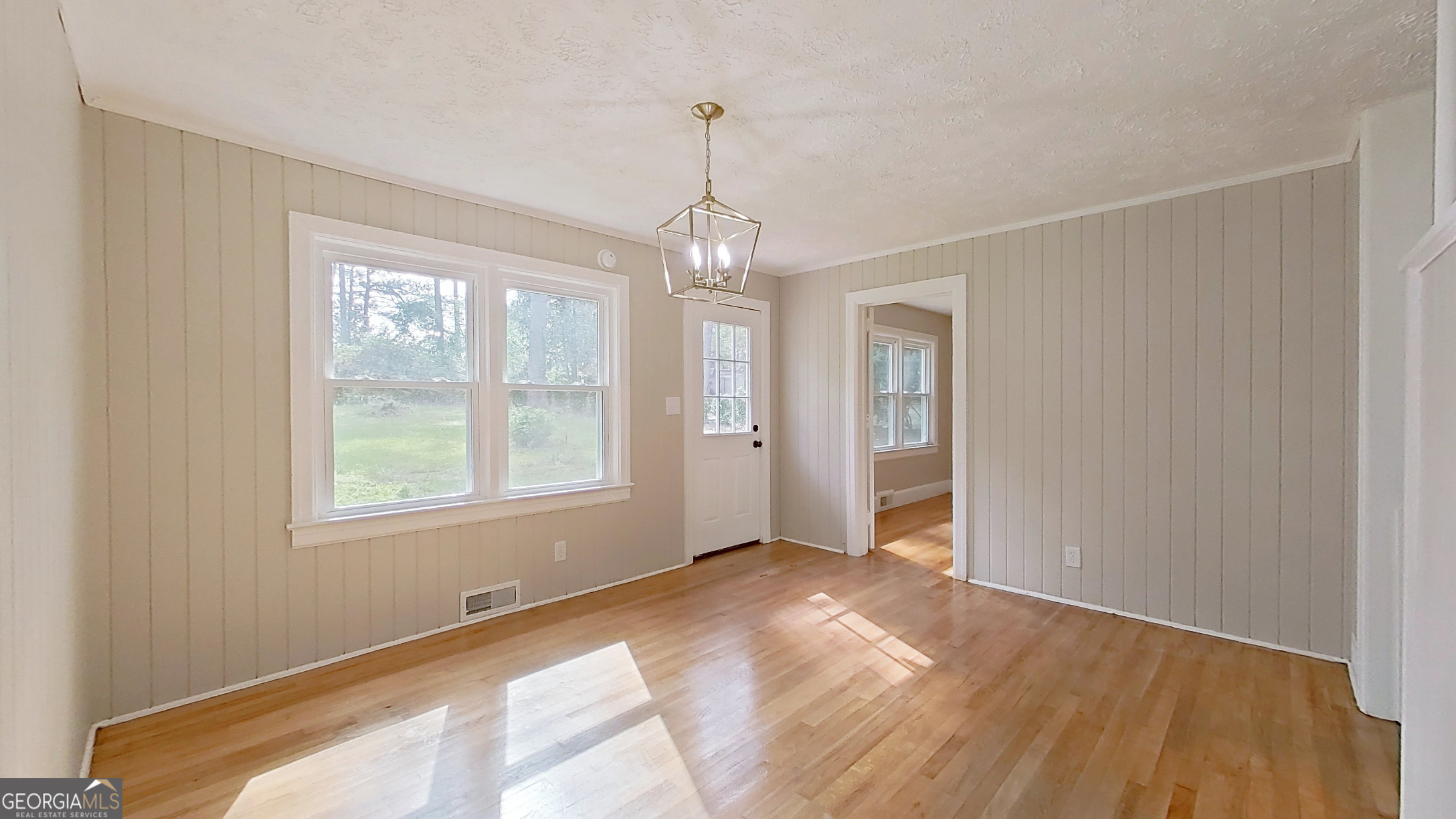 481 4th Street Southeast Cairo, GA 39828 - Photo 21 of 55 a view of an empty room with wooden floor and a window