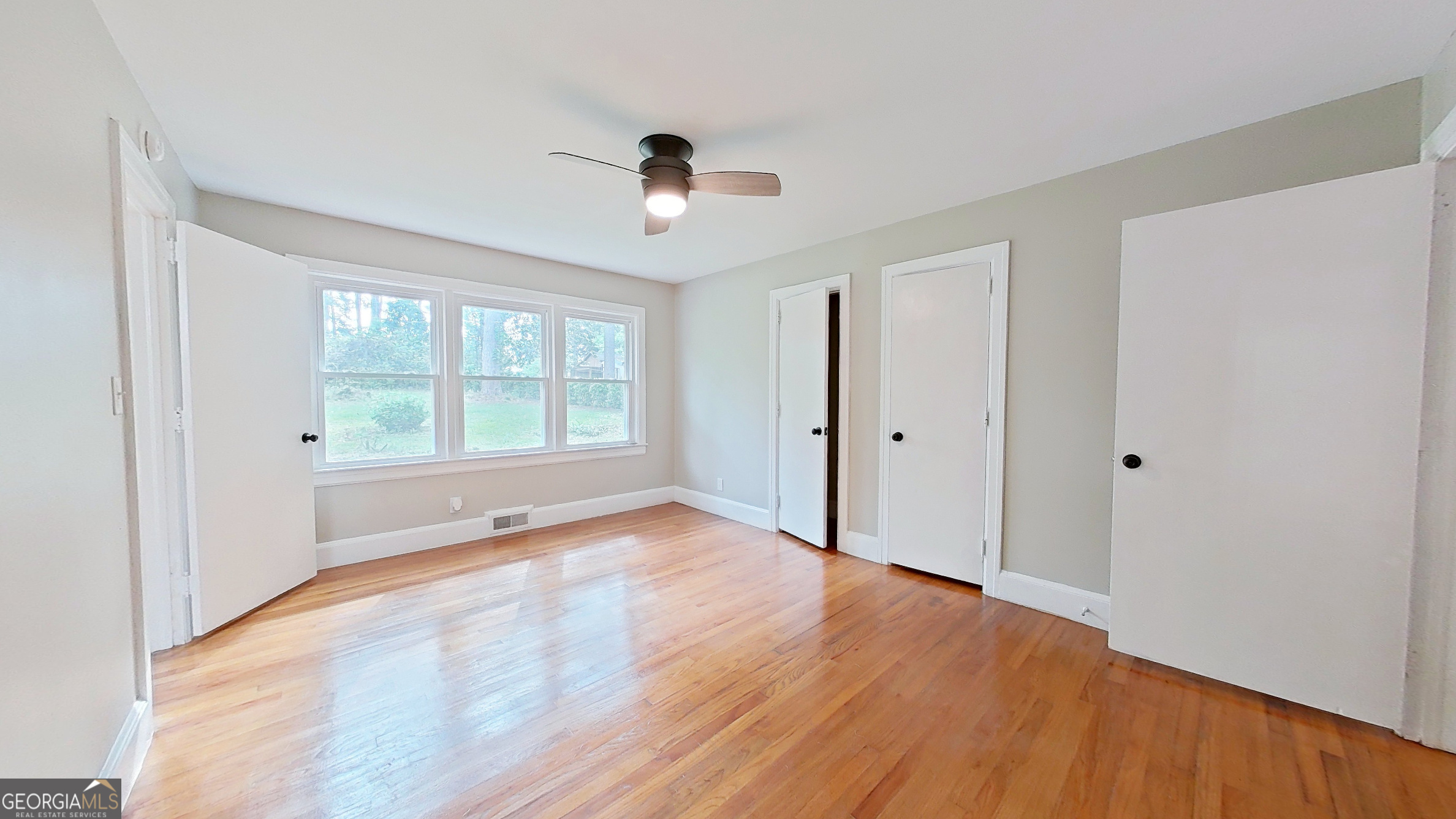 481 4th Street Southeast Cairo, GA 39828 - Photo 25 of 55 an empty room with wooden floor and windows