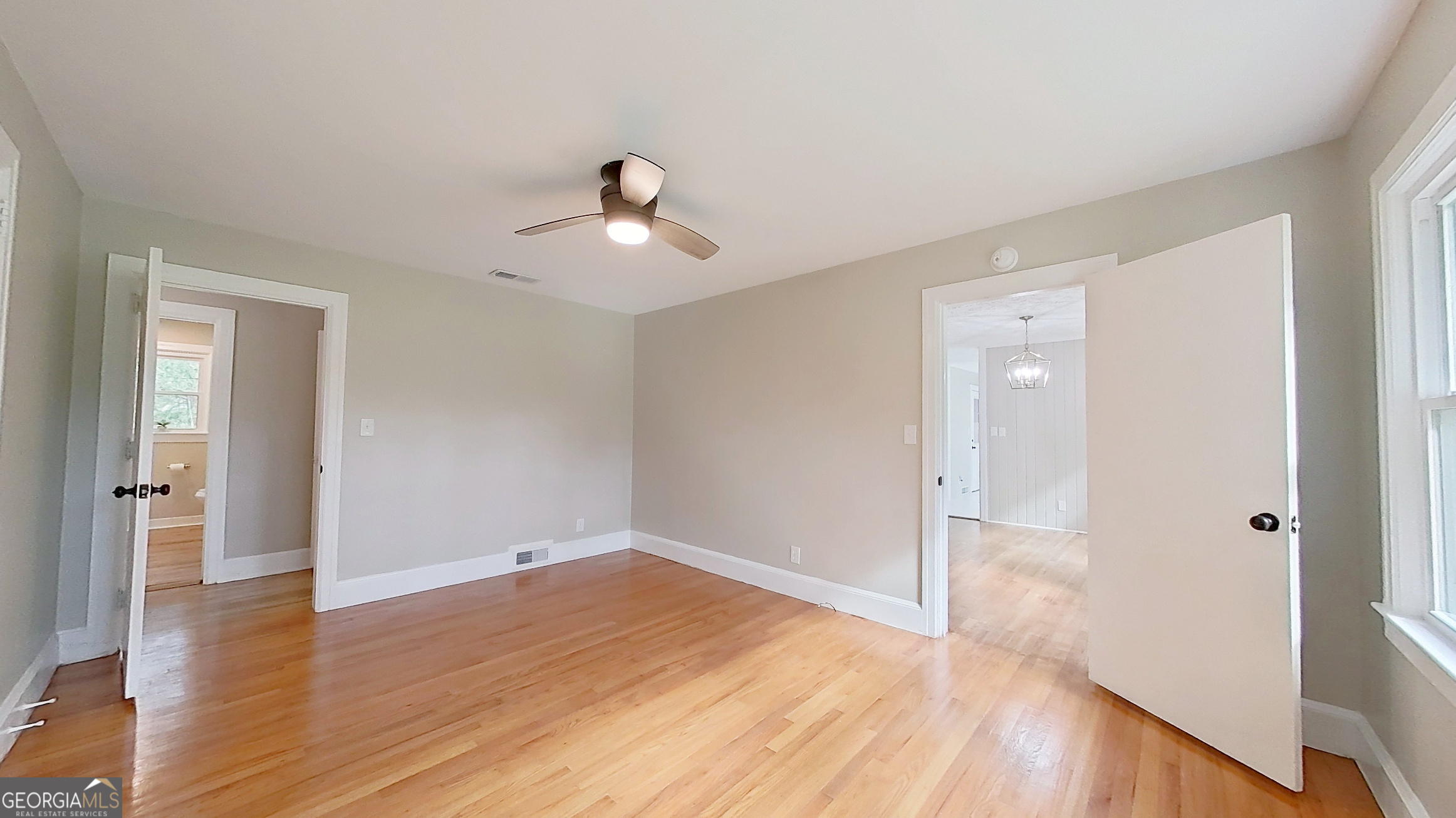 481 4th Street Southeast Cairo, GA 39828 - Photo 26 of 55 a view of empty room with wooden floor and ceiling fan