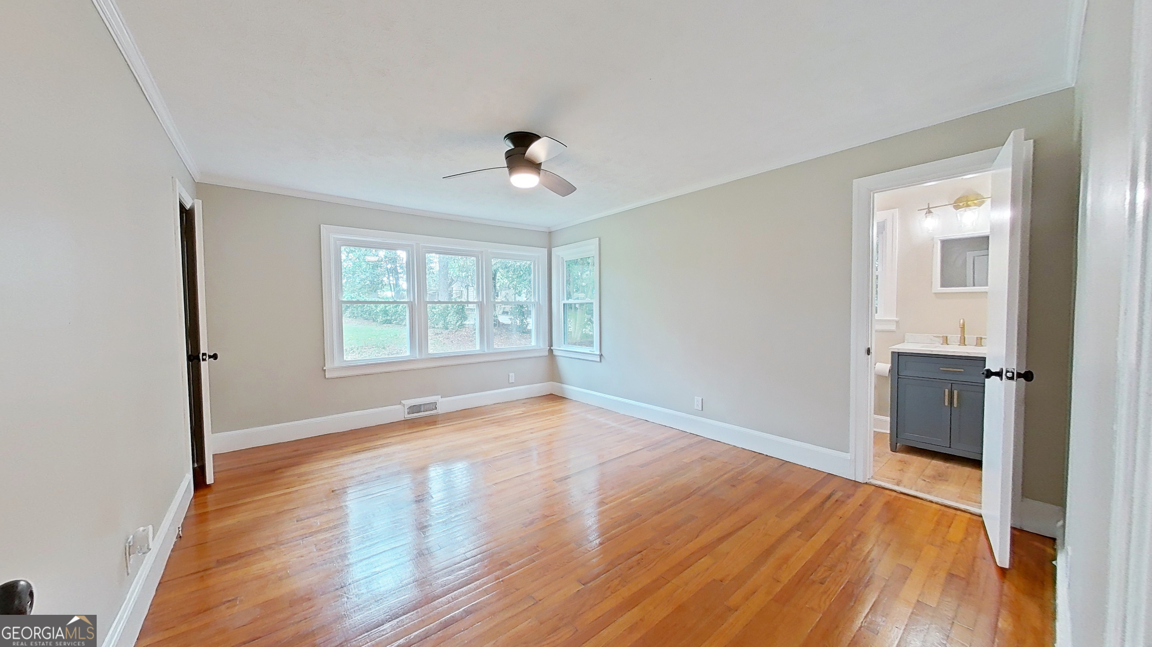 481 4th Street Southeast Cairo, GA 39828 - Photo 31 of 55 a view of an empty room with wooden floor and a window