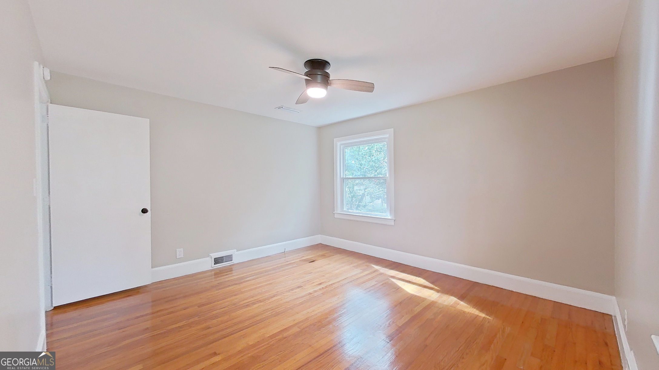 481 4th Street Southeast Cairo, GA 39828 - Photo 41 of 55 an empty room with a window and ceiling fan