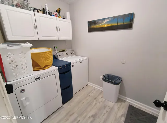 a view of a storage and utility room with a washer dryer