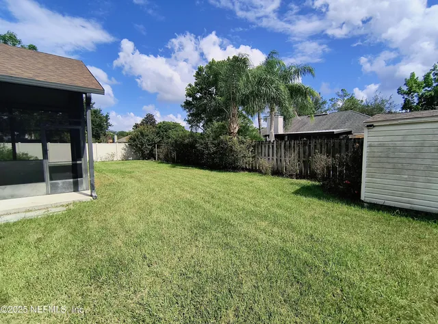 a view of a backyard with a cabin
