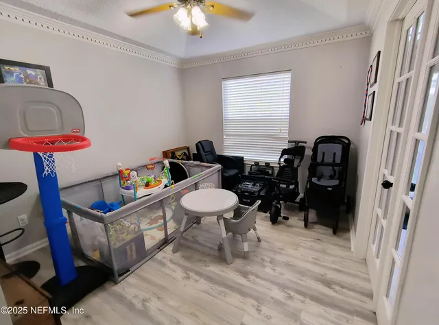 a living room with furniture a flat screen tv and a window