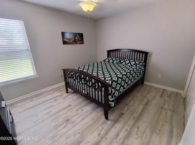 a view of a room with wooden floor and window