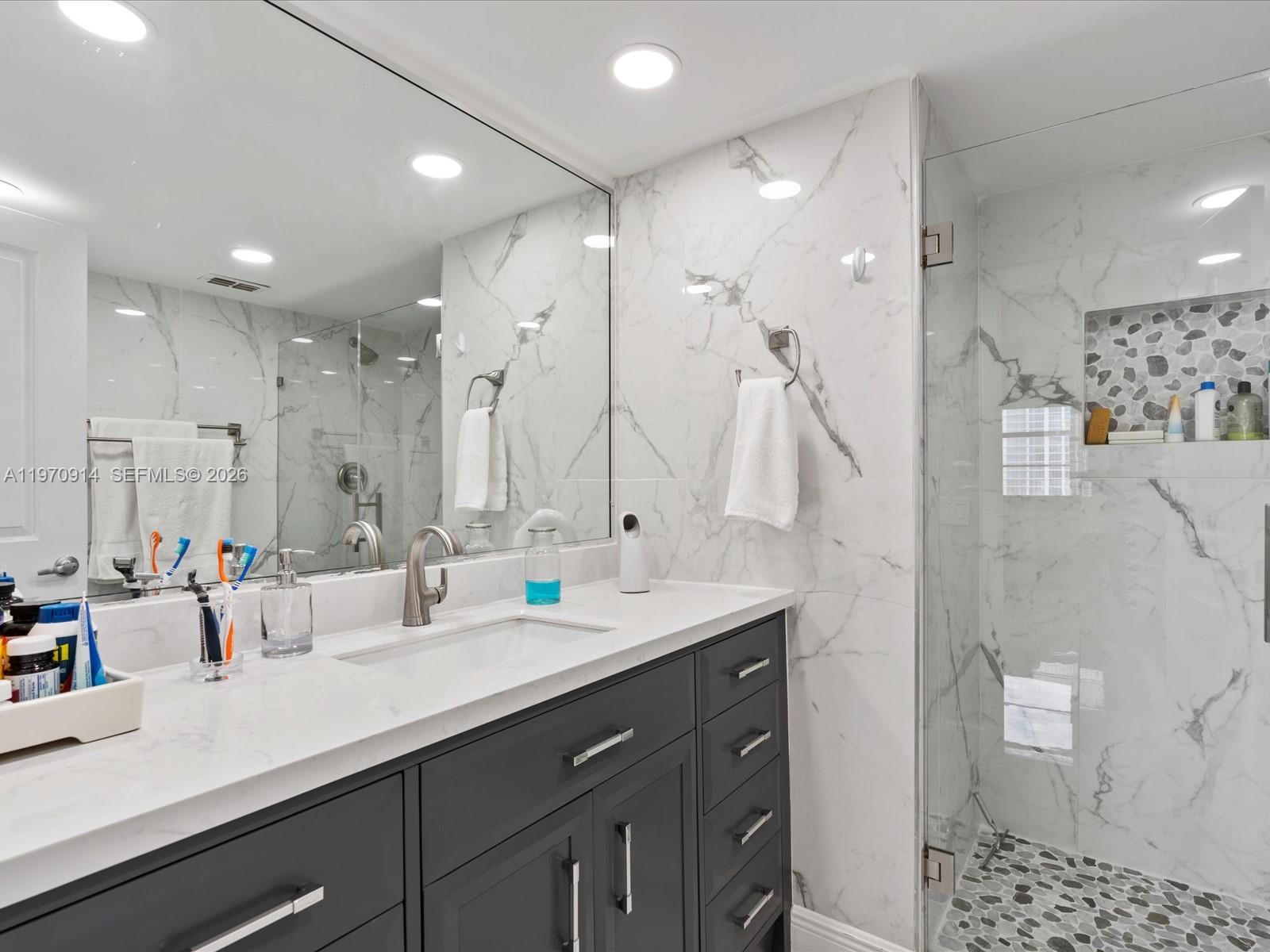336 North Birch Road, Unit PH Fort Lauderdale, FL 33304 - Photo 25 of 68 a bathroom with double vanity sink and a mirror