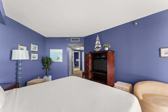 a bathroom with a granite countertop sink a toilet and a mirror