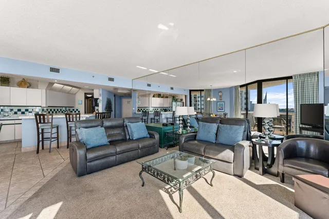 a living room with furniture wooden floor and a flat screen tv