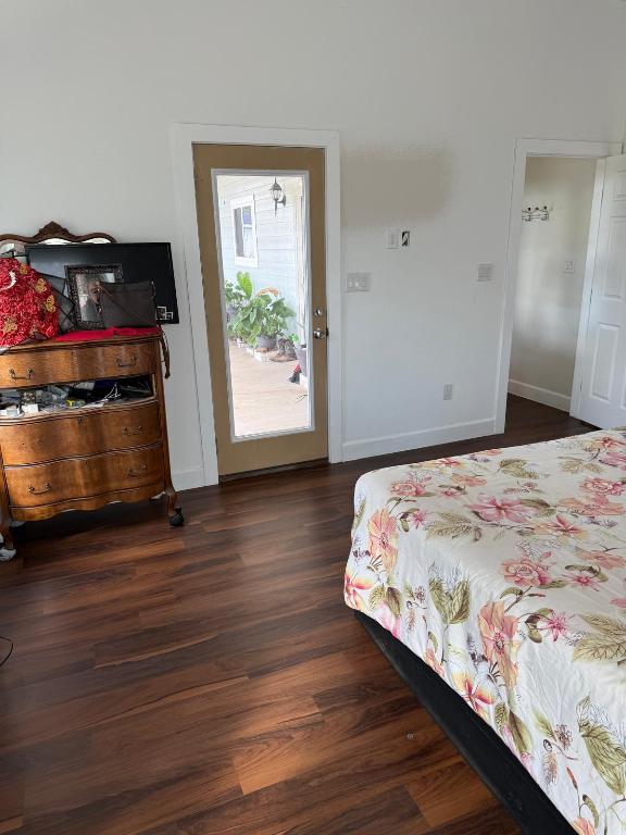 497 Brown Road McDade, TX 78650 - Photo 19 of 22 Bedroom featuring dark wood-style floors and baseboards
