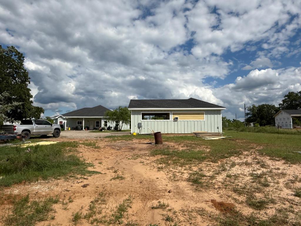 497 Brown Road McDade, TX 78650 - Photo 2 of 22 View of front of house featuring board and batten siding