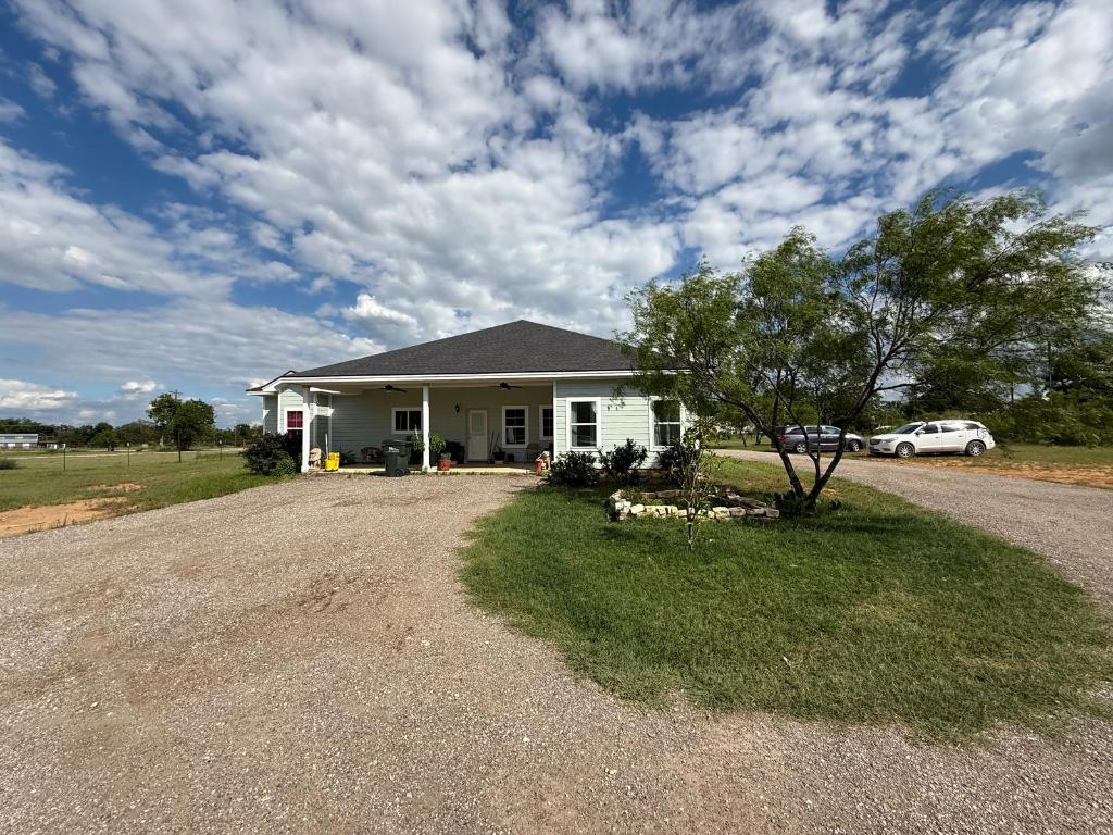497 Brown Road McDade, TX 78650 - Photo 4 of 22 Bungalow-style home with driveway, a ceiling fan, and a front yard