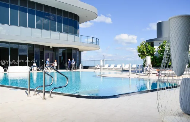 a view of a swimming pool with outdoor seating