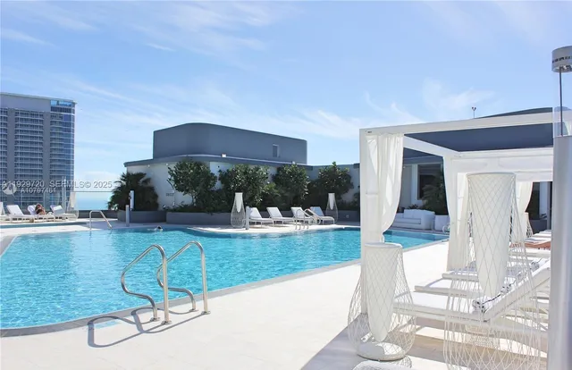 a view of a swimming pool and lounge chair
