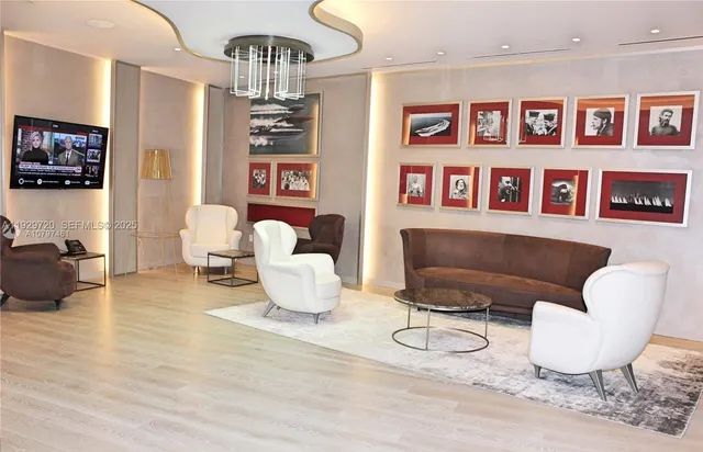 a living room with furniture and a chandelier