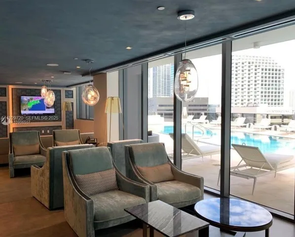 a living room with furniture and a floor to ceiling window